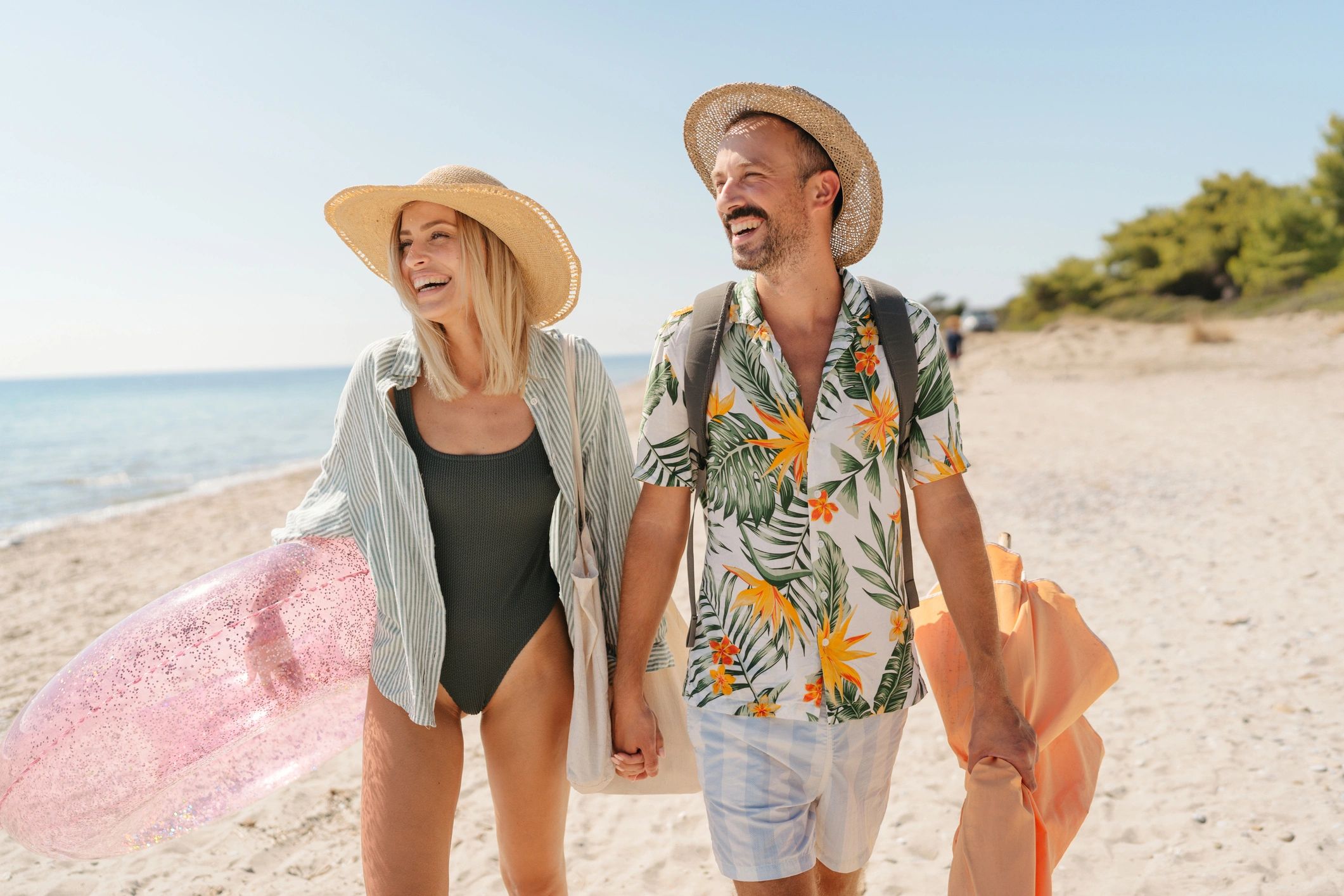Starr and Paul smiling on a sunny beach